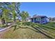 Home exterior features a blue facade, green grass, and mature trees at 2807 W Granfield Ave, Plant City, FL 33563