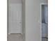 Clean hallway with a view to a laundry room including a washer and dryer at 2807 W Granfield Ave, Plant City, FL 33563
