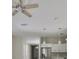 A ceiling fan and pendant lights brighten the stainless appliances and white cabinetry in the kitchen at 2807 W Granfield Ave, Plant City, FL 33563