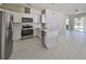 Well-lit kitchen features stainless steel appliances, white cabinetry and countertops, and an island at 2807 W Granfield Ave, Plant City, FL 33563