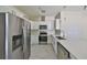 The kitchen is equipped with stainless steel appliances, white cabinets, and light countertops at 2807 W Granfield Ave, Plant City, FL 33563
