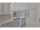 Open-concept kitchen with quartz countertops, stainless steel appliances, and seamless access to the backyard at 2807 W Granfield Ave, Plant City, FL 33563