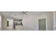 A bright, neutral living area with a doorway to the kitchen, and a sliding door to the patio at 2807 W Granfield Ave, Plant City, FL 33563