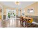 Bright dining room features wood floors, a decorative light fixture, wainscoting, and an adjacent sun room at 3000 2Nd N Ave, St Petersburg, FL 33713