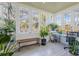 Bright and airy sun room filled with natural light and a variety of plants for a peaceful ambiance at 3000 2Nd N Ave, St Petersburg, FL 33713