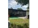 Backyard view features a screened-in porch and well maintained lawn at 3106 W Dewey, Tampa, FL 33607