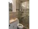 Bathroom featuring a sleek glass-enclosed shower with updated fixtures and neutral tile at 3106 W Dewey, Tampa, FL 33607