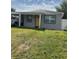 Charming single-story home with a yellow front door, carport, and cozy front yard at 3106 W Dewey, Tampa, FL 33607