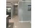 Hallway with white tile flooring leading into the kitchen with stainless steel appliances at 3106 W Dewey, Tampa, FL 33607