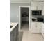 Kitchen with white cabinets, stainless steel microwave, and quartz countertops at 3106 W Dewey, Tampa, FL 33607