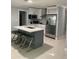 Modern kitchen island, quartz countertops, stainless appliances, and white cabinetry at 3106 W Dewey, Tampa, FL 33607