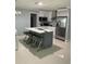 Modern kitchen with island, stainless steel appliances, and white cabinets at 3106 W Dewey, Tampa, FL 33607