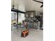 Outdoor kitchen features stone accents, stainless appliances, dining table, and ceiling fans at 3106 W Dewey, Tampa, FL 33607