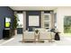 Modern living room featuring stylish furniture, large windows, and neutral decor at 36084 Joseph Blake St, Zephyrhills, FL 33541