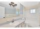 This bathroom features a bath and shower combo, tile flooring, and plenty of counter space at 37451 Hickory Hill Ln, Dade City, FL 33525