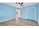 This bright bedroom has gray wood-look floors and ample closet space at 37451 Hickory Hill Ln, Dade City, FL 33525