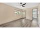 Bright bedroom features new floors, a ceiling fan, and ample closet space, creating a cozy retreat at 37451 Hickory Hill Ln, Dade City, FL 33525