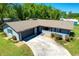 Charming single-story home with a well-maintained lawn and a driveway leading to an attached garage at 37451 Hickory Hill Ln, Dade City, FL 33525