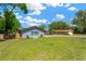 Charming single-story home with a well-maintained lawn and a driveway leading to an attached garage at 37451 Hickory Hill Ln, Dade City, FL 33525