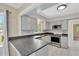 This updated kitchen features modern appliances, sleek countertops, and stylish gray cabinetry at 37451 Hickory Hill Ln, Dade City, FL 33525