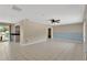 Spacious living room featuring tiled floors, neutral wall paint, and a ceiling fan at 37451 Hickory Hill Ln, Dade City, FL 33525