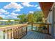 View of the pool with a wooden deck and stairs under a bright blue sky at 37451 Hickory Hill Ln, Dade City, FL 33525