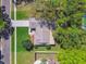 Aerial view of a well-maintained property with mature landscaping, a two-car garage, and proximity to a pool at 3952 Applegate Cir, Brandon, FL 33511