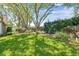 Beautifully landscaped backyard with verdant lawn, mature trees, and manicured shrubs, perfect for relaxation and outdoor activities at 3952 Applegate Cir, Brandon, FL 33511