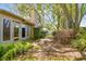 Charming backyard featuring a stone pathway, well-maintained lawn, and lush landscaping, offering a private outdoor retreat at 3952 Applegate Cir, Brandon, FL 33511