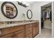 Bathroom with dual sinks, granite countertops, updated hardware, and a well-organized walk-in closet at 3952 Applegate Cir, Brandon, FL 33511