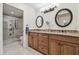 Elegant bathroom with a double vanity, granite countertops, and a spacious glass-enclosed shower at 3952 Applegate Cir, Brandon, FL 33511
