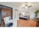 Comfortable bedroom with a chair, ceiling fan, wooden floors, and a built-in closet at 3952 Applegate Cir, Brandon, FL 33511