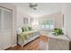 Bedroom with hardwood floors, a window with shutters, and a trundle bed at 3952 Applegate Cir, Brandon, FL 33511