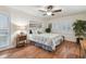 Comfortable bedroom with a floral-patterned bedspread, wooden floors, and a serene atmosphere at 3952 Applegate Cir, Brandon, FL 33511