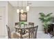 Dining area features a glass-top table, decorative lighting, and views of lush greenery at 3952 Applegate Cir, Brandon, FL 33511