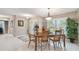 Dining room with a neutral color scheme, large window, and decorative light fixture at 3952 Applegate Cir, Brandon, FL 33511