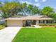 Charming single-story home with a well-manicured lawn, stone accents, and mature landscaping, creating an inviting facade at 3952 Applegate Cir, Brandon, FL 33511