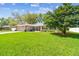 Landscaped front yard featuring mature trees and bushes add beauty and shade to the property at 3952 Applegate Cir, Brandon, FL 33511