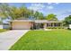 Charming single-story home with a well-manicured lawn, stone accents and attached two car garage at 3952 Applegate Cir, Brandon, FL 33511