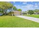 View of the front yard and front of the home with an attached garage and long driveway at 3952 Applegate Cir, Brandon, FL 33511