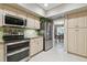 Kitchen area featuring stainless steel appliances, granite countertops, and a view into the dining room at 3952 Applegate Cir, Brandon, FL 33511