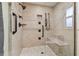 Modern shower with stylish tile, bench seating, and multiple showerheads for a spa-like experience at 3952 Applegate Cir, Brandon, FL 33511