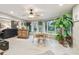 Relaxing sun room features a ceiling fan, ample natural light, and lush greenery at 3952 Applegate Cir, Brandon, FL 33511