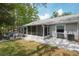 Lovely backyard featuring a screened lanai and a stone patio with lush lawn at 39650 Us Highway 19 N # 615, Tarpon Springs, FL 34689