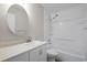 Well-lit bathroom with a large round mirror and shower-tub combination at 39650 Us Highway 19 N # 615, Tarpon Springs, FL 34689