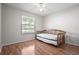 Bright bedroom with laminate wood floors and a daybed positioned by the window at 39650 Us Highway 19 N # 615, Tarpon Springs, FL 34689