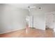 Spacious bedroom featuring laminate floors, a ceiling fan, and access to a bathroom at 39650 Us Highway 19 N # 615, Tarpon Springs, FL 34689
