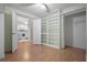 Open bedroom featuring laminated floors and an open view to the kitchen, providing an airy layout at 39650 Us Highway 19 N # 615, Tarpon Springs, FL 34689