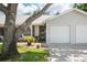 Charming single-story home featuring a one-car garage, well-kept lawn, and delightful curb appeal at 39650 Us Highway 19 N # 615, Tarpon Springs, FL 34689