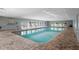 Bright indoor community pool with clear water and ample seating, perfect for year-round enjoyment at 39650 Us Highway 19 N # 615, Tarpon Springs, FL 34689